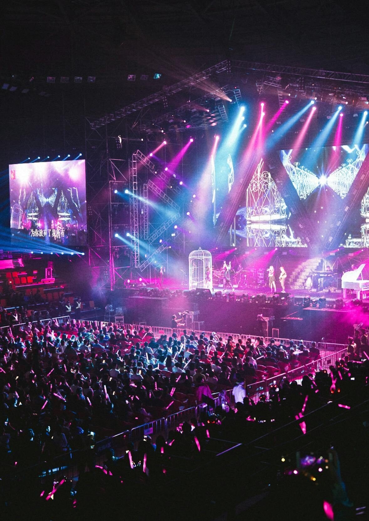 Colorful live concert with vibrant lighting, energetic crowd, and dynamic stage performance.